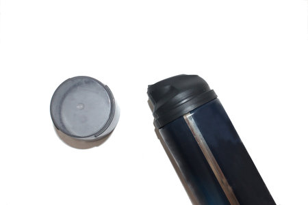 Close-up of an aluminum canister and lid on a white background.