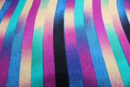 Colorful striped fabric as background, close up. Rainbow colors.