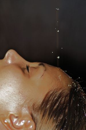 Sprinkling on young girl faceの写真素材