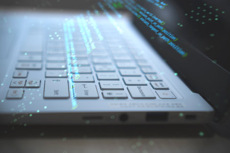 computer programming on laptop, source code shows on laptop keyboard