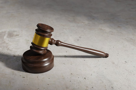 A courtroom gavel on a concrete floor background, 3d renderingの写真素材