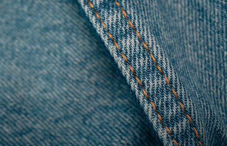 closeup jean fabric texture with stitch backgroundsの写真素材