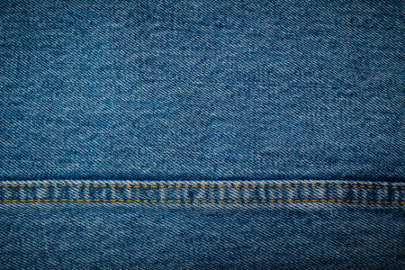 closeup jean fabric texture with stitch backgroundsの写真素材