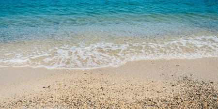 Summer beach sand, blue waves and white foamの写真素材