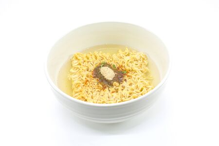 Famous home made asian instant noodle floating on boiled water with unhealthy seasoning powder (monosodium glutamate) in a ceramic bowl on white background. Horizontal shot.の写真素材