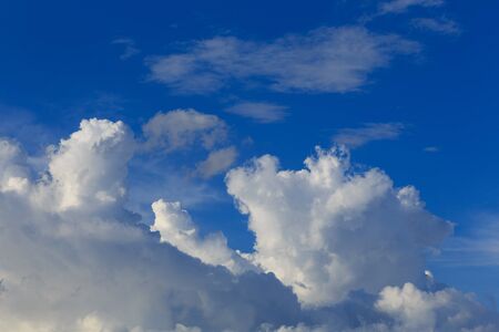 White clouds against the blue sky background in sunny cloudy summer day.の写真素材