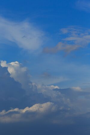 White clouds against the blue sky background in sunny cloudy summer day.の写真素材