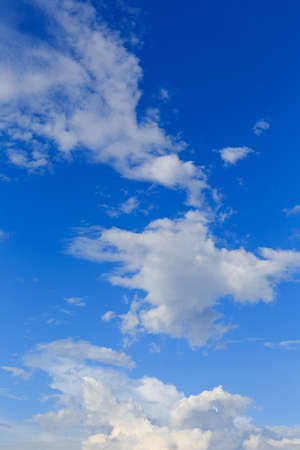 White clouds against the blue sky background in sunny cloudy summer day.の写真素材
