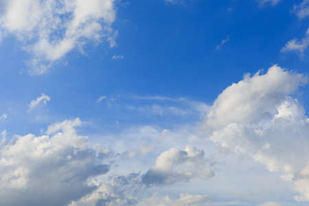 White clouds against the blue sky background in sunny cloudy summer day.の写真素材