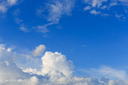 White clouds against the blue sky background in sunny cloudy summer day.の写真素材