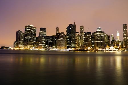 Lower Manhattan in New York City at night with reflection in water の写真素材