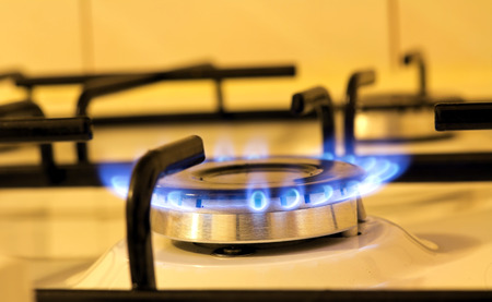 A closeup view of the flames of a kitchen stoveの写真素材