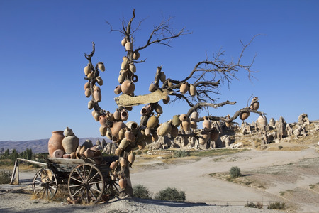 Jugs on a tree with Cappadocia landscape in background, Turkeyの写真素材