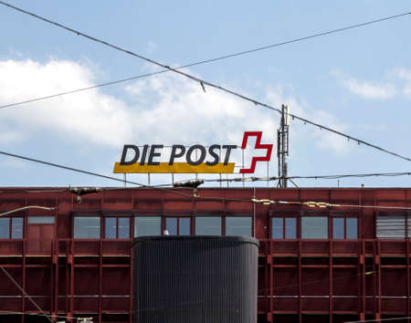 Basel, SWITZERLAND: Swiss Post sign on the wall of a post office. Swiss Post a public company, which provides national postal service for Switzerland.のeditorial素材
