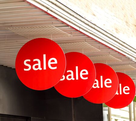 Sale signs in shop window at Basel shopping street