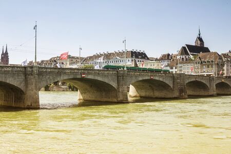 View of the old town of Basel, Switzerland with the River Rhine and the historic bridge and historic...