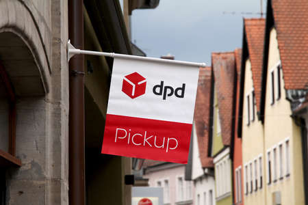 Forchheim, GERMANY : DPD Paket Shop flag and logo on the entrance of a shop offering pick-up service for online orders. DPD is a parcel delivery company owned by GeoPost La Poste Franceのeditorial素材