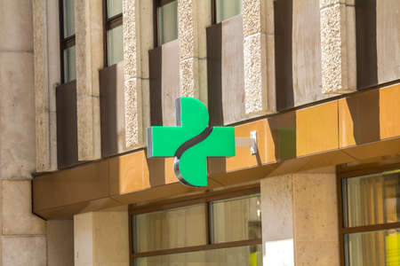 Close up of pharmacy sign / logo. Green cross. Medicine, pharmacy, health business.のeditorial素材