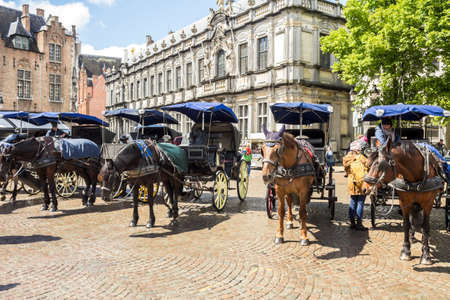 Bruges, Belgium : Horse carriage on Grote Markt square. Belgian city of Bruges (Brugge) is UNESCO world heritage listed for its medieval center.のeditorial素材