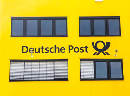 Furth, Germany : DEUTSCHE POST cargo terminal and logo on the building .Deutsche Post AG is a German courier company and the world's largest.のeditorial素材