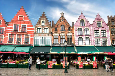 Famous old colorful buildings at Market square in Bruges, Belgium. Popular Flemish city with almost intact medieval architecture.のeditorial素材