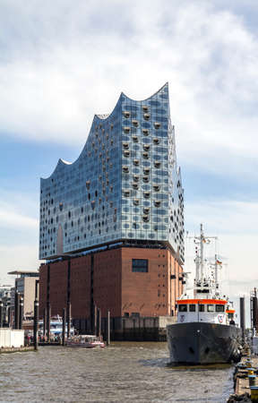 Hamburg, Germany: The Concert Hall Elbphilharmonie behind the roofs of the historic warehouse district (German: Speicherstadt)のeditorial素材