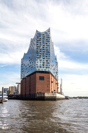 Hamburg, Germany: The Concert Hall Elbphilharmonie behind the roofs of the historic warehouse district (German: Speicherstadt)のeditorial素材