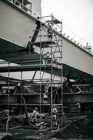 A monochromatic picture of five workers at a construction site