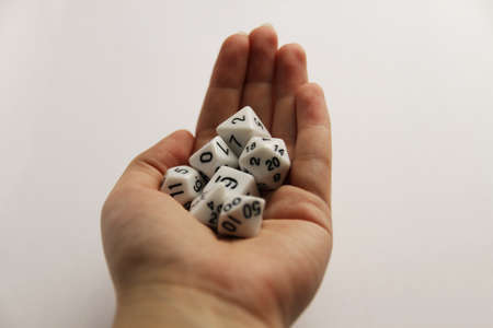 Hand holding the set of white diceの写真素材