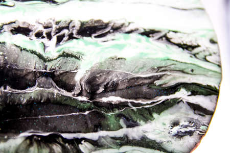 Part of abstract epoxy resin art: black, white and green waves painting textureの写真素材