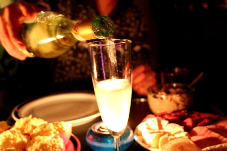 bubbly glass of champagne by candlelight, food still lifeの写真素材