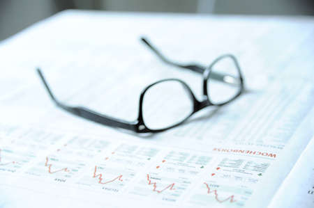 Glasses on a financial newspaper