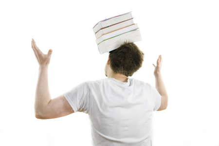 Young man balancing with books on his head