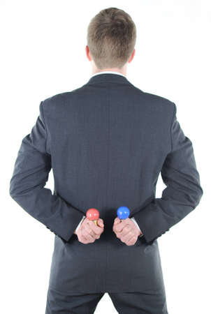 Businessman with red and blue light bulb behind his backの写真素材