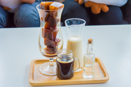 Cafe Coffee Enjoyment Happiness Relaxation Concept Iced coffee cubes with milk on the tableの写真素材