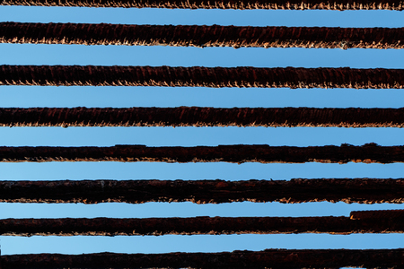 the old iron bars on blue sky background, daylight