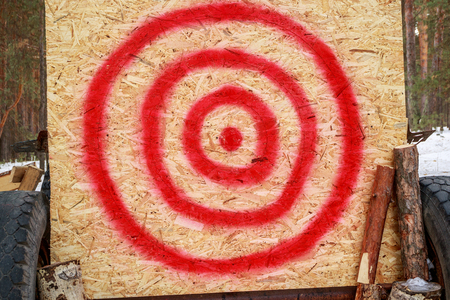 homemade target on a plywood sheet of wood, uneven red circlesの写真素材