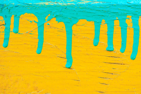 dripping green paint on the yellow, the old cracked paint background texture, two colorsの写真素材