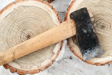 scoop and fuel chocks view from above, lying ax for chopping firewood on stumps in winterの写真素材