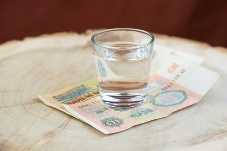 old 10 rubles ussr on the table under a glass of vodkaの写真素材