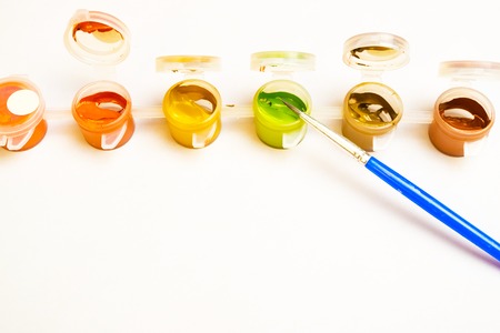 a lot of containers with paint in a row on them is a paintbrush, the creative processの写真素材