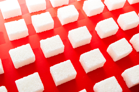 lump sugar on a red background perspective rowsの写真素材
