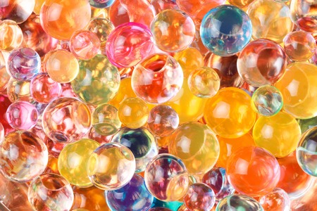 the predominant yellow color of the circular hydrogel balls spread out in chaotic order, a multitude of round shapesの写真素材