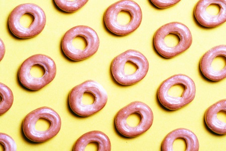 pattern from Russian bagels on a yellow background, donuts on a diagonal