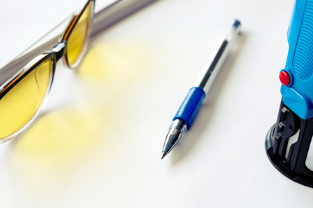 print on the print near the pen and yellow glasses for the eyes, white paper backgroundの写真素材