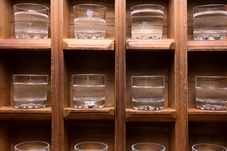 wooden shelf with plenty of space for shots, each glass its placeの写真素材