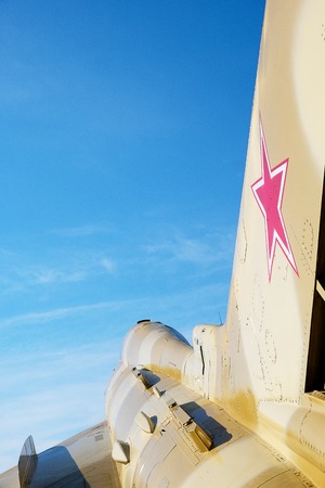 red star on the tail of a military aircraft fighter ussr against the blue sky, view from the rear of the combat aircraftの写真素材