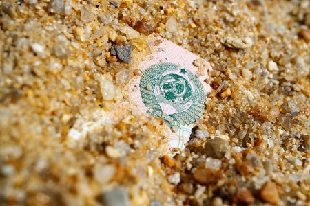 at the dump of the history of 10 rubles of the USSR with the coat of arms thrown yellow sand, the...