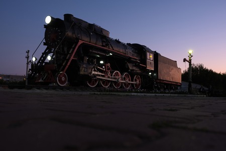 early morning vintage steam locomotive on sky background, view from earth retro transportの写真素材