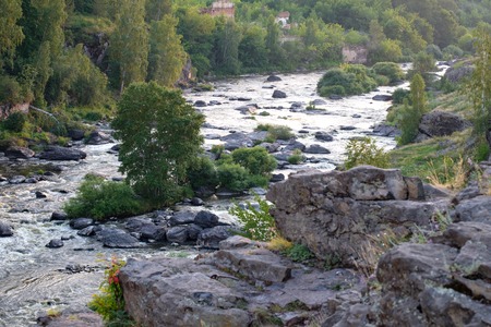 the rapids on the river Iset in Russia, the landscape is a top view of a rocky shore on which grows...